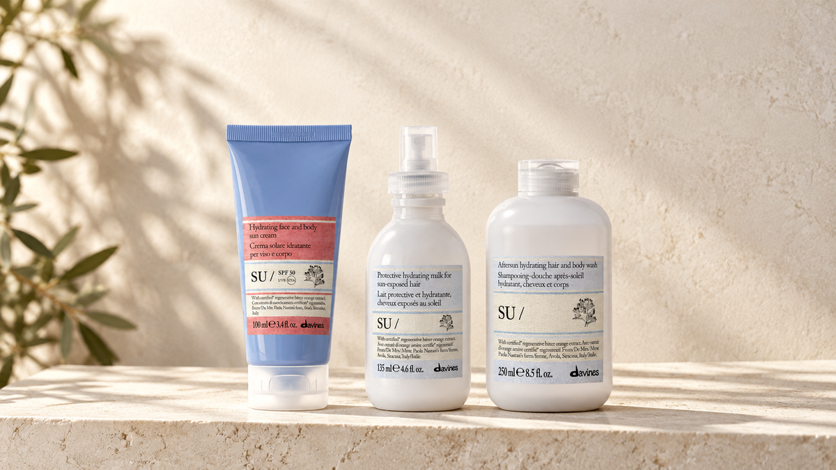 Davines SU solkrem SPF 50, Hair Milk og Hair & Body Wash på lys steinplate