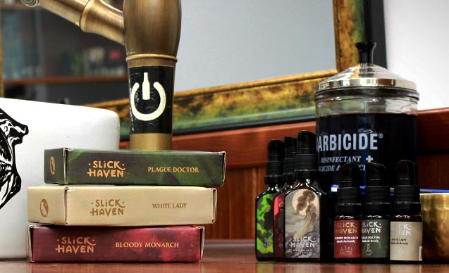 Slick Haven grooming products, including Plague Doctor, White Lady, and Bloody Monarch, displayed on a barbershop counter.