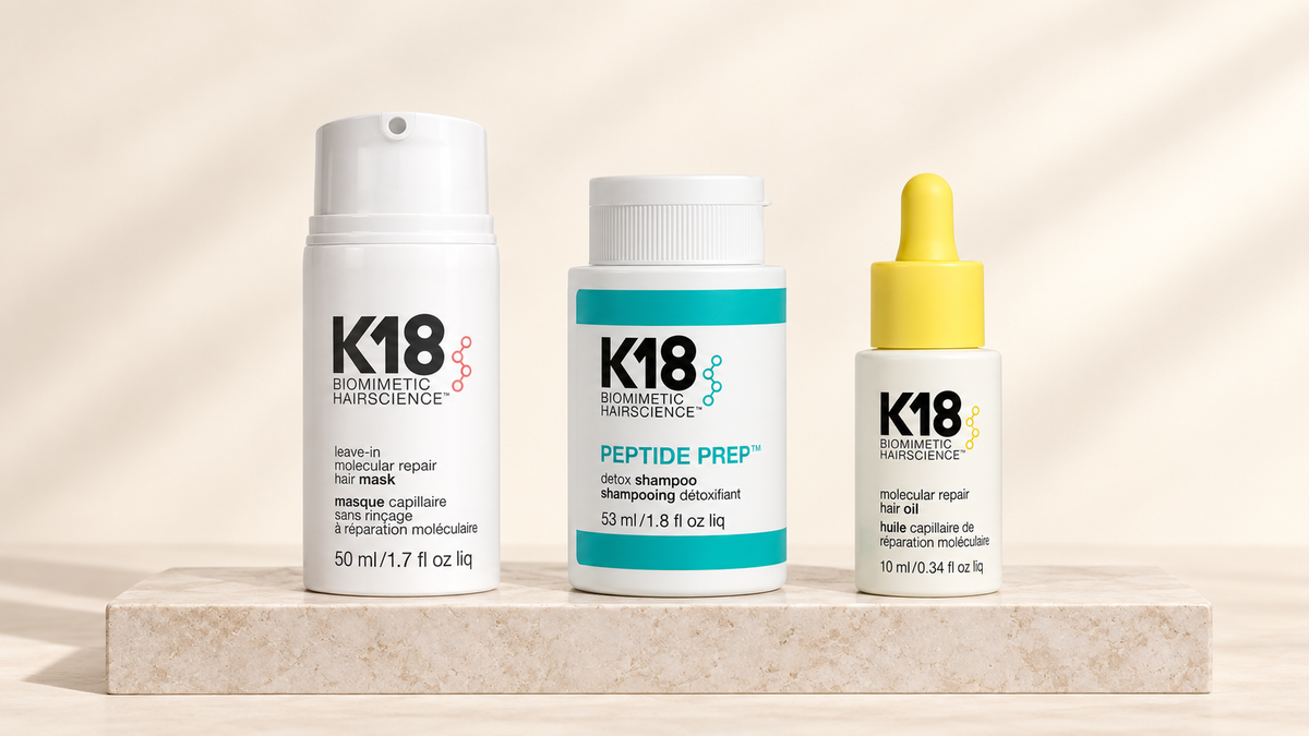 K18 Molecular Repair Mask, Peptide Prep Detox Shampoo og Hair Oil på lys steinplate