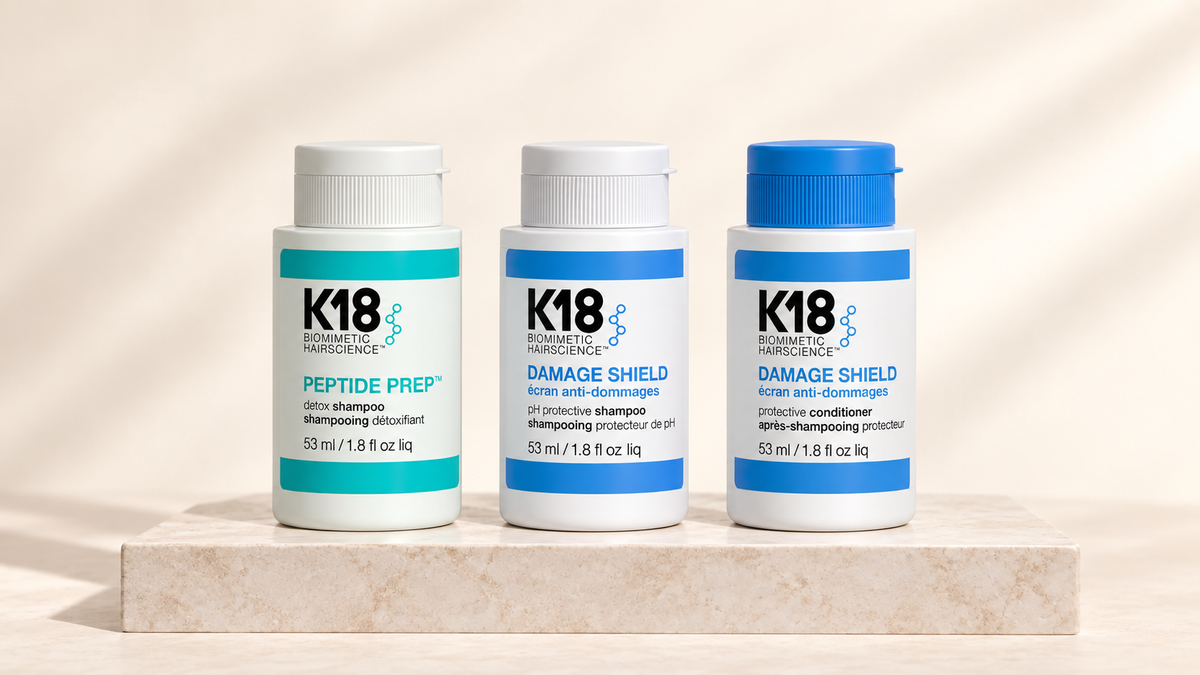 K18 Peptide Prep Detox Shampoo og Damage Shield sjampo og balsam på lys steinplate
